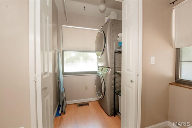 7040 Oak Shadow Ln, High Ridge, MO 63049 - laundry room with stacked washing machine and dryer and wood finished floors