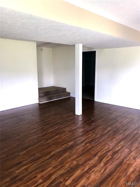 1462 Windle Rd, Cuba, MO 65453 - finished below grade area featuring wood finished floors and a textured ceiling