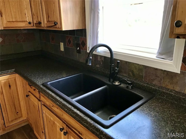 1462 Windle Rd, Cuba, MO 65453 - kitchen featuring dark countertops, decorative backsplash, and brown cabinetry