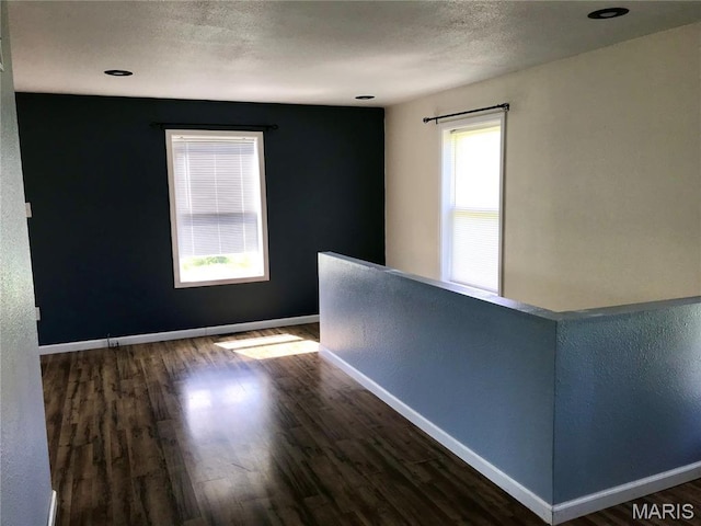 1462 Windle Rd, Cuba, MO 65453 - unfurnished room featuring wood finished floors, a textured ceiling, and a textured wall