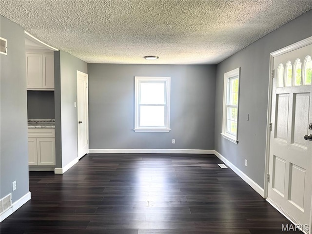 4404 Saint Leo Ln, Saint Ann, MO 63074 - entryway with a textured ceiling and dark wood finished floors