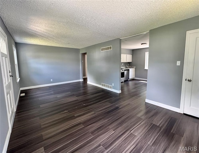 4404 Saint Leo Ln, Saint Ann, MO 63074 - spare room with dark wood-type flooring and a textured ceiling