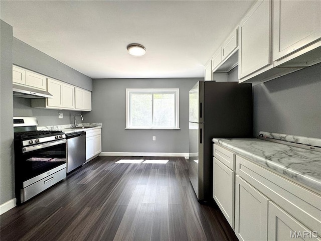 4404 Saint Leo Ln, Saint Ann, MO 63074 - kitchen featuring stainless steel appliances, under cabinet range hood, light countertops, dark wood-style floors, and white cabinetry