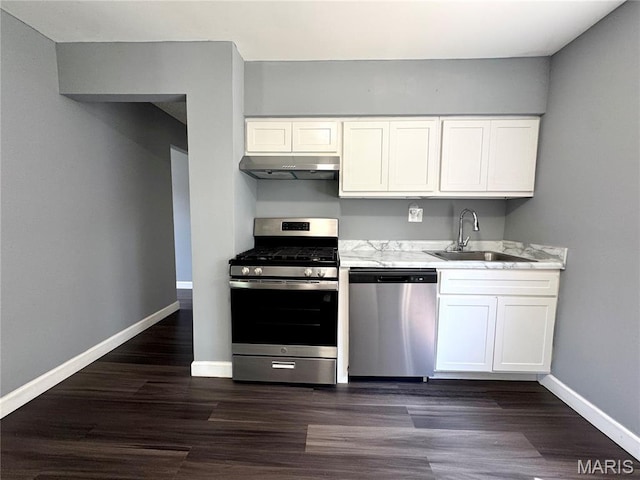 4404 Saint Leo Ln, Saint Ann, MO 63074 - kitchen featuring stainless steel appliances, ventilation hood, white cabinets, and dark wood finished floors