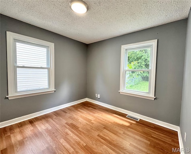4404 Saint Leo Ln, Saint Ann, MO 63074 - unfurnished room with light wood finished floors and a textured ceiling