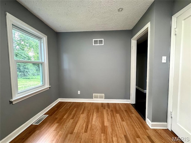 4404 Saint Leo Ln, Saint Ann, MO 63074 - unfurnished room with wood finished floors and a textured ceiling