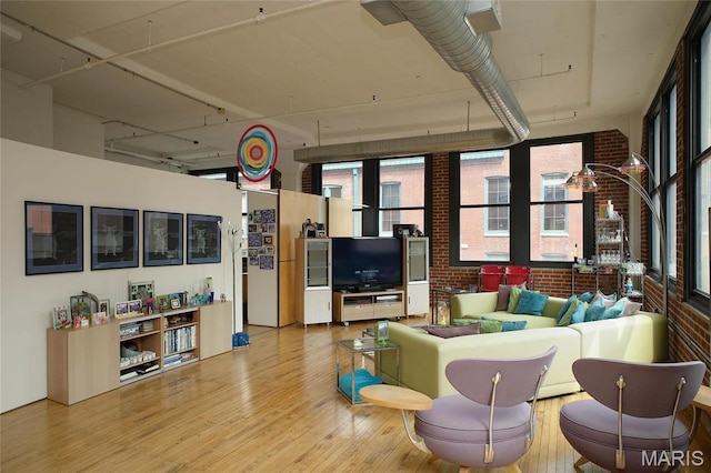 1010 Saint Charles St Unit 802, Saint Louis, MO 63101 - living room featuring wood finished floors and brick wall