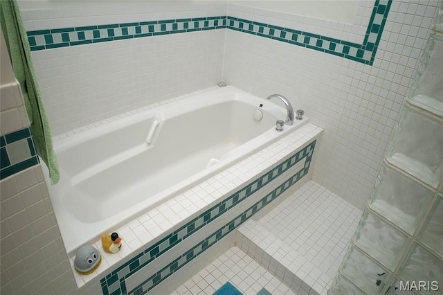 1010 Saint Charles St Unit 802, Saint Louis, MO 63101 - bathroom featuring tile walls, a garden tub, and tile patterned floors