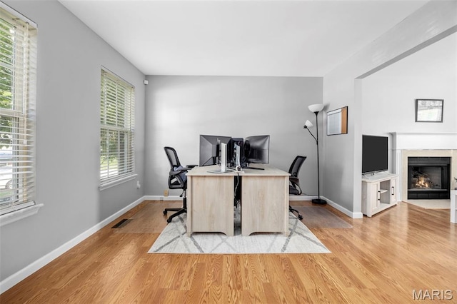 2330 Eagle Pines Dr, Saint Charles, MO 63303 - office space featuring light wood-style flooring and a fireplace with flush hearth