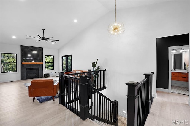 2803 Poolbrook Way, Washington, MO 63090 - stairway with wood finished floors, high vaulted ceiling, recessed lighting, ceiling fan, and a fireplace