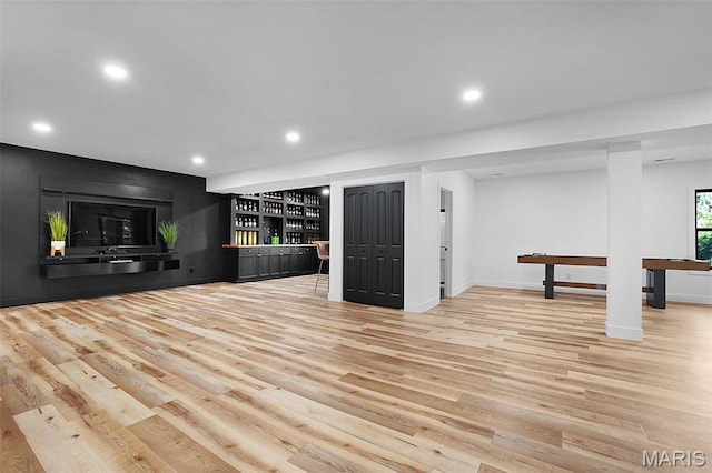 2803 Poolbrook Way, Washington, MO 63090 - unfurnished living room with bar area, wood finished floors, and recessed lighting