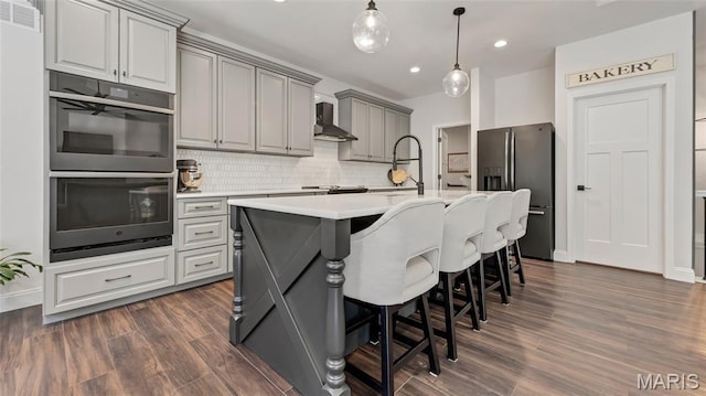 5065 Fox Bridge Rd, Wildwood, MO 63069 - kitchen with stainless steel appliances, gray cabinets, wall chimney range hood, light countertops, and dark wood-style floors