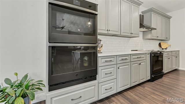 5065 Fox Bridge Rd, Wildwood, MO 63069 - kitchen featuring black appliances, light countertops, backsplash, dark wood-style floors, and wall chimney range hood
