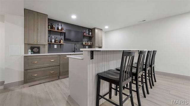 5065 Fox Bridge Rd, Wildwood, MO 63069 - indoor wet bar with light wood finished floors and recessed lighting