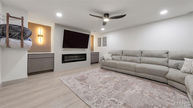 5065 Fox Bridge Rd, Wildwood, MO 63069 - living area with a ceiling fan, light wood-style flooring, a large fireplace, recessed lighting, and electric panel