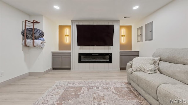 5065 Fox Bridge Rd, Wildwood, MO 63069 - living room featuring light wood-type flooring, electric panel, recessed lighting, and a fireplace