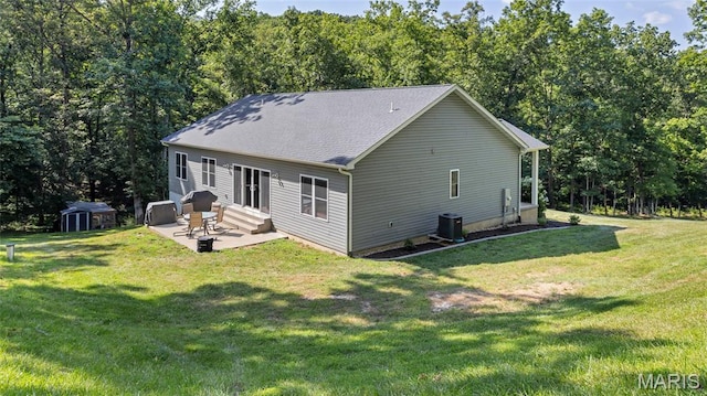 5065 Fox Bridge Rd, Wildwood, MO 63069 - back of property with a patio, entry steps, a storage unit, and a lawn