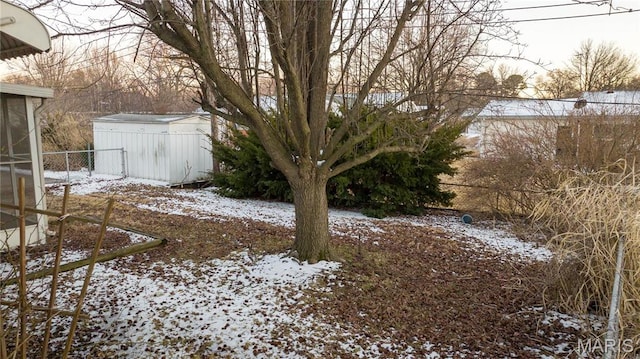 2480 Cambridge Dr, Florissant, MO 63033 - yard covered in snow featuring a storage unit