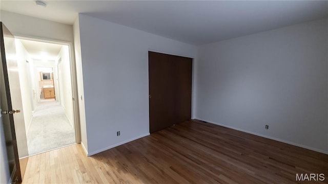 2480 Cambridge Dr, Florissant, MO 63033 - unfurnished bedroom with wood finished floors and a closet