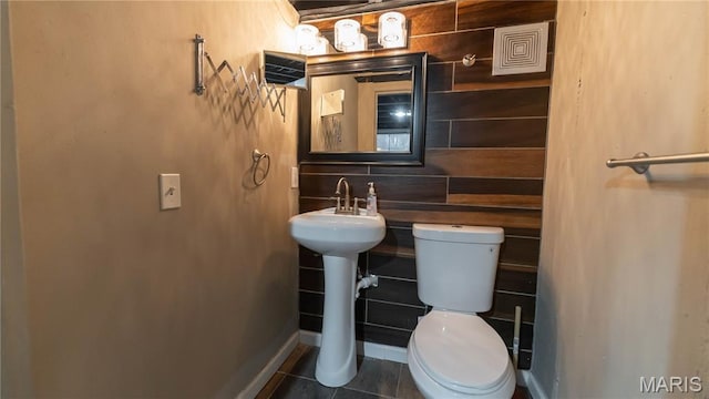 2480 Cambridge Dr, Florissant, MO 63033 - half bathroom with toilet and tile patterned floors