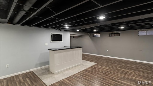 2480 Cambridge Dr, Florissant, MO 63033 - finished below grade area featuring wood finished floors and a dry bar