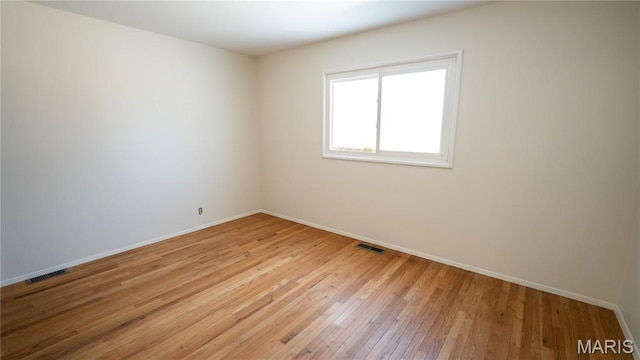 2480 Cambridge Dr, Florissant, MO 63033 - unfurnished room featuring baseboards and light wood-style floors