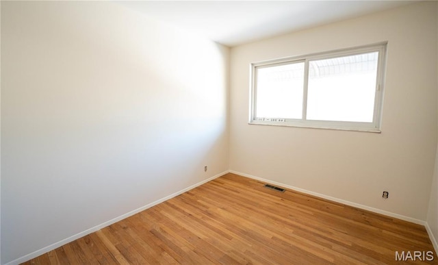 2480 Cambridge Dr, Florissant, MO 63033 - unfurnished room featuring baseboards and light wood-style floors