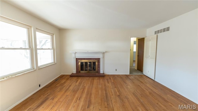 2480 Cambridge Dr, Florissant, MO 63033 - unfurnished living room featuring wood finished floors and a fireplace