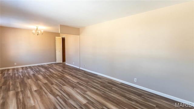 2480 Cambridge Dr, Florissant, MO 63033 - empty room featuring a chandelier and dark wood-style flooring
