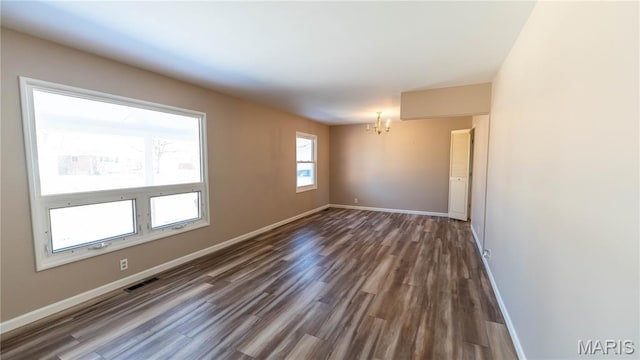 2480 Cambridge Dr, Florissant, MO 63033 - spare room with a chandelier and dark wood-style floors