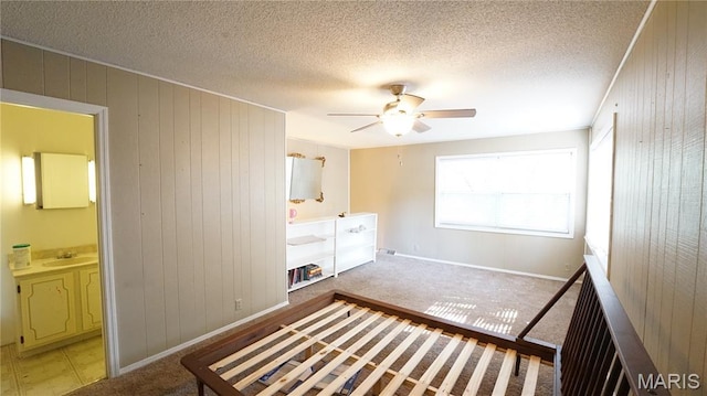 18937 Wayne Route D, Wappapello, MO 63966 - unfurnished bedroom with wooden walls, a textured ceiling, ceiling fan, and ensuite bath