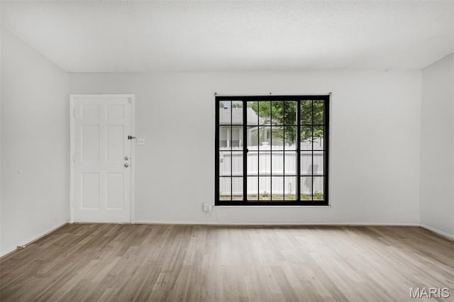 2449 Forest Shadows Dr, Saint Louis, MO 63136 - empty room with wood finished floors and baseboards