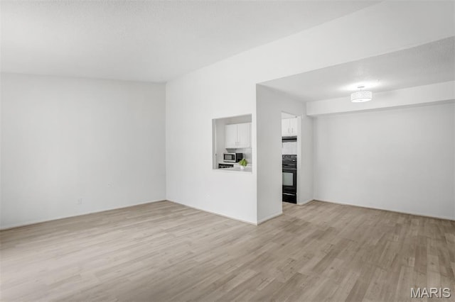 2449 Forest Shadows Dr, Saint Louis, MO 63136 - unfurnished living room featuring light wood-type flooring