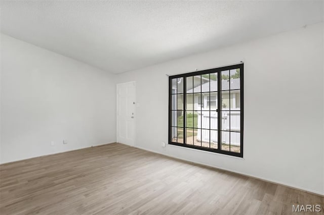 2449 Forest Shadows Dr, Saint Louis, MO 63136 - empty room featuring wood finished floors and a textured ceiling