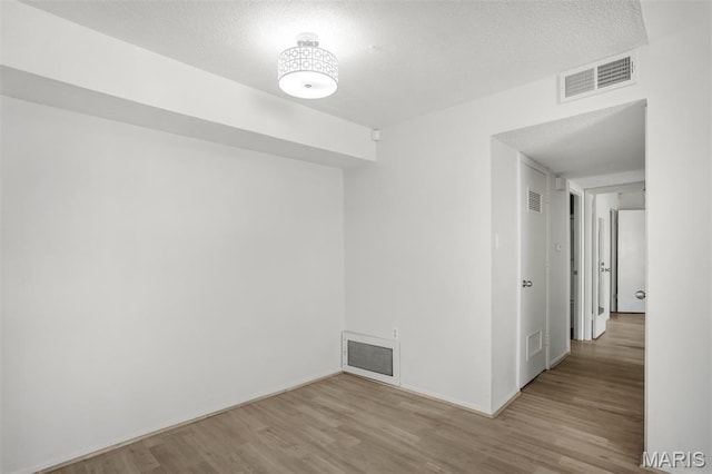 2449 Forest Shadows Dr, Saint Louis, MO 63136 - spare room with wood finished floors and a textured ceiling