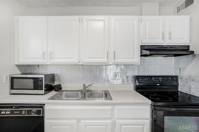 2449 Forest Shadows Dr, Saint Louis, MO 63136 - kitchen featuring black appliances, under cabinet range hood, white cabinetry, light countertops, and tasteful backsplash