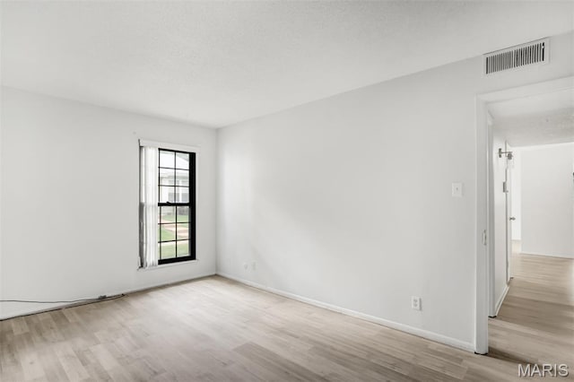 2449 Forest Shadows Dr, Saint Louis, MO 63136 - empty room featuring wood finished floors and a textured ceiling
