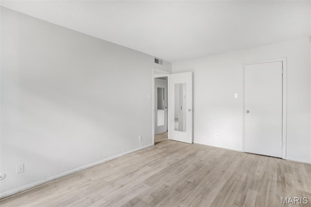 2449 Forest Shadows Dr, Saint Louis, MO 63136 - unfurnished bedroom featuring light wood-style flooring and baseboards