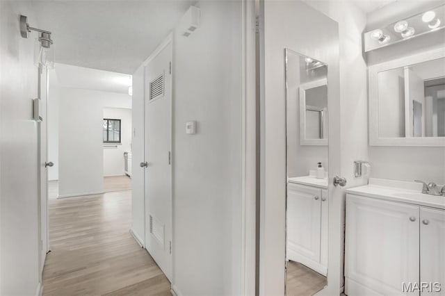 2449 Forest Shadows Dr, Saint Louis, MO 63136 - bathroom featuring vanity and wood finished floors