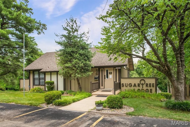 2449 Forest Shadows Dr, Saint Louis, MO 63136 - view of front of home with a shingled roof, uncovered parking, and a front lawn