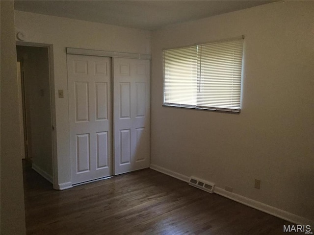 8552 Church Rd, Saint Louis, MO 63147 - unfurnished bedroom featuring a closet and dark wood-type flooring