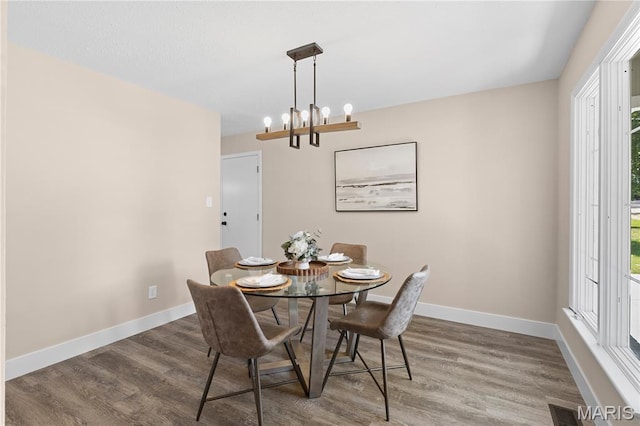 1618 Clock Tower Dr, Saint Louis, MO 63138 - dining area featuring wood finished floors, a chandelier, and healthy amount of natural light