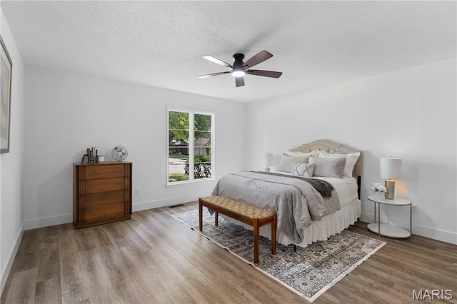 1618 Clock Tower Dr, Saint Louis, MO 63138 - bedroom featuring wood finished floors, a textured ceiling, and a ceiling fan