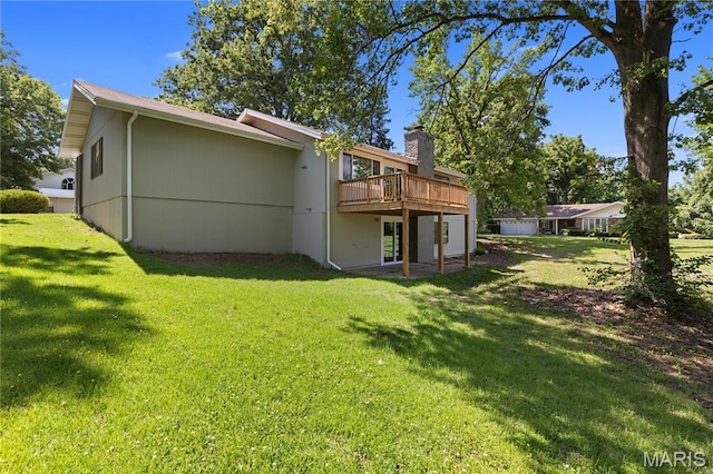 1618 Clock Tower Dr, Saint Louis, MO 63138 - rear view of house with a wooden deck, a yard, and a chimney