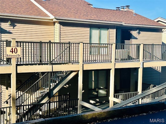 40 Robinwood Unit 2C, Lake Ozark, MO 65049 - rear view of house featuring roof with shingles