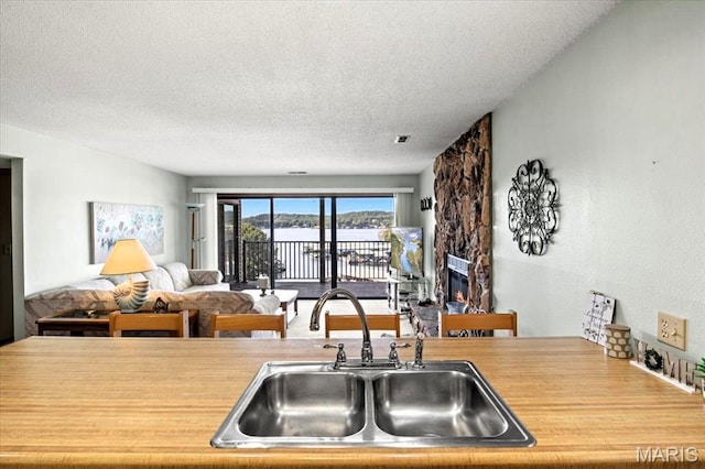40 Robinwood Unit 2C, Lake Ozark, MO 65049 - kitchen with a textured ceiling, open floor plan, and light countertops