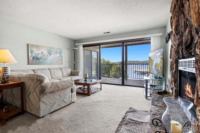 40 Robinwood Unit 2C, Lake Ozark, MO 65049 - living room with carpet floors, a textured ceiling, and a fireplace