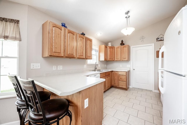 132 Timberlake, Damiansville, IL 62215 - kitchen featuring freestanding refrigerator, a peninsula, light tile patterned floors, a breakfast bar area, and light countertops