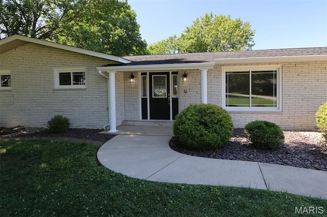 5 Lakeshore Dr, New Baden, IL 62265 - view of exterior entry featuring brick siding, covered porch, and a lawn