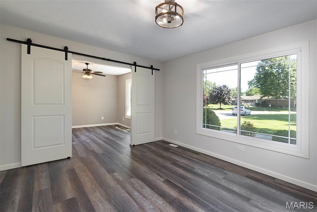 5 Lakeshore Dr, New Baden, IL 62265 - empty room featuring a barn door, dark wood-style floors, and a textured ceiling
